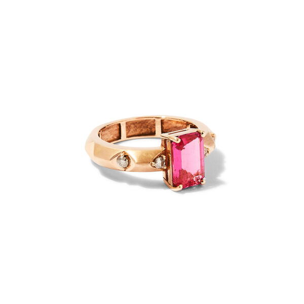 18k rose gold ring with rectangular pink rubellite center and brown diamond accents on a polished band, studio background